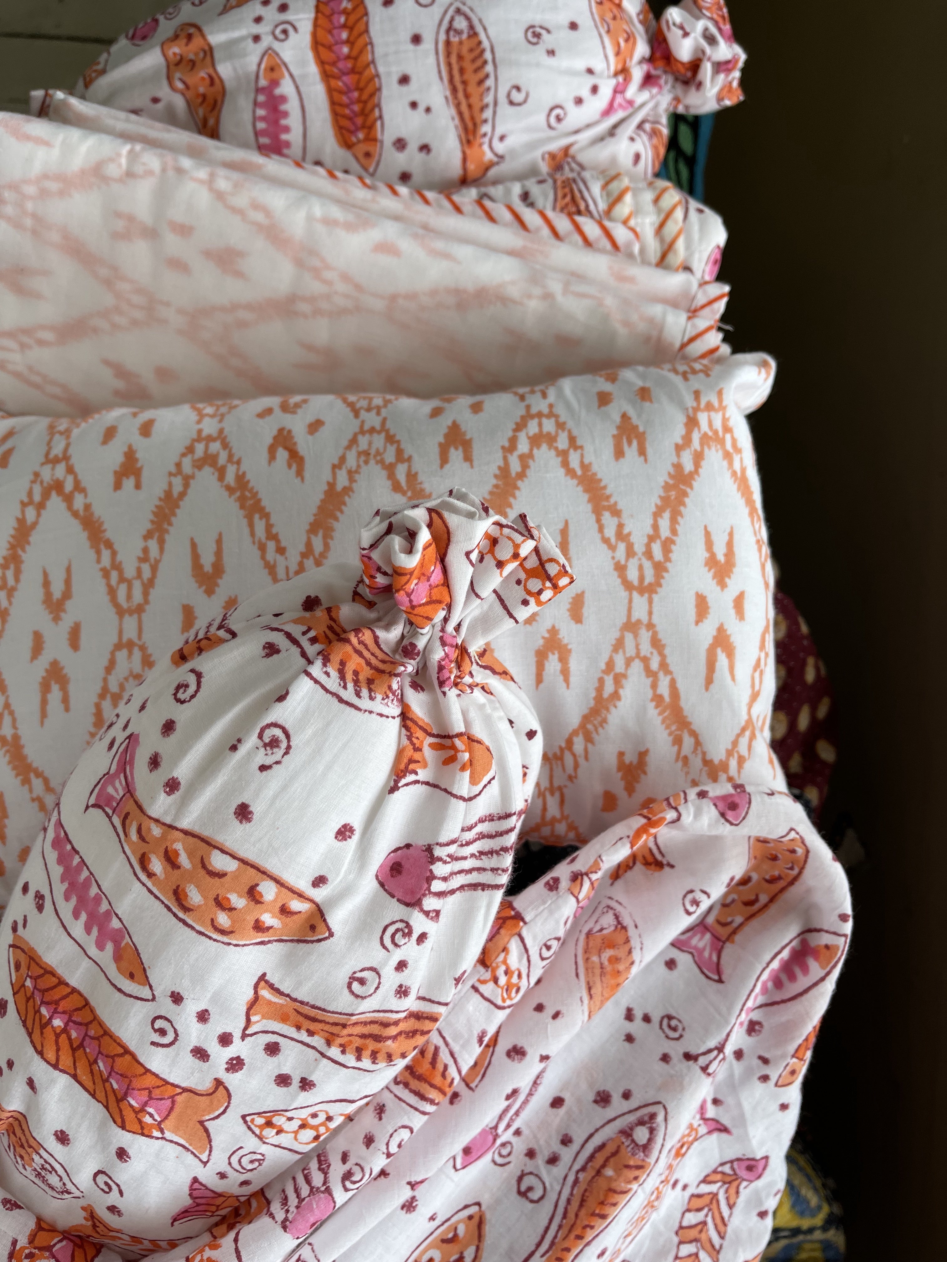 Handblock printed cotton baby quilt, machine stitched in small squares for easy care and washing. Lightly padded with cotton.