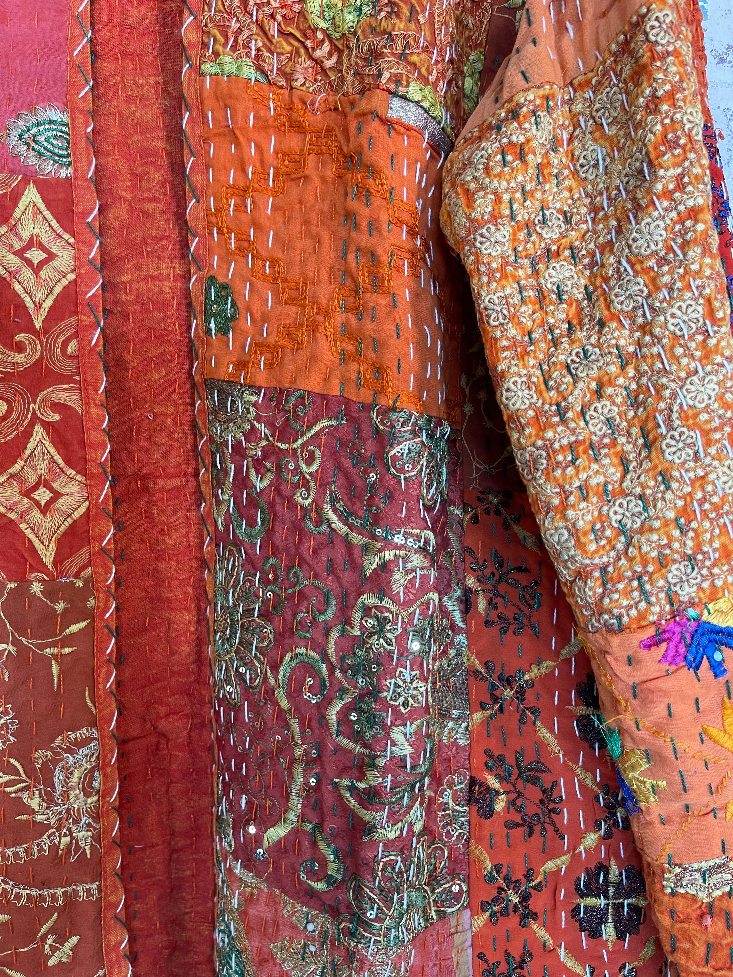 Delightful kantha coat in patchwork of embroidered patterns and sequins. The inside lining plain.