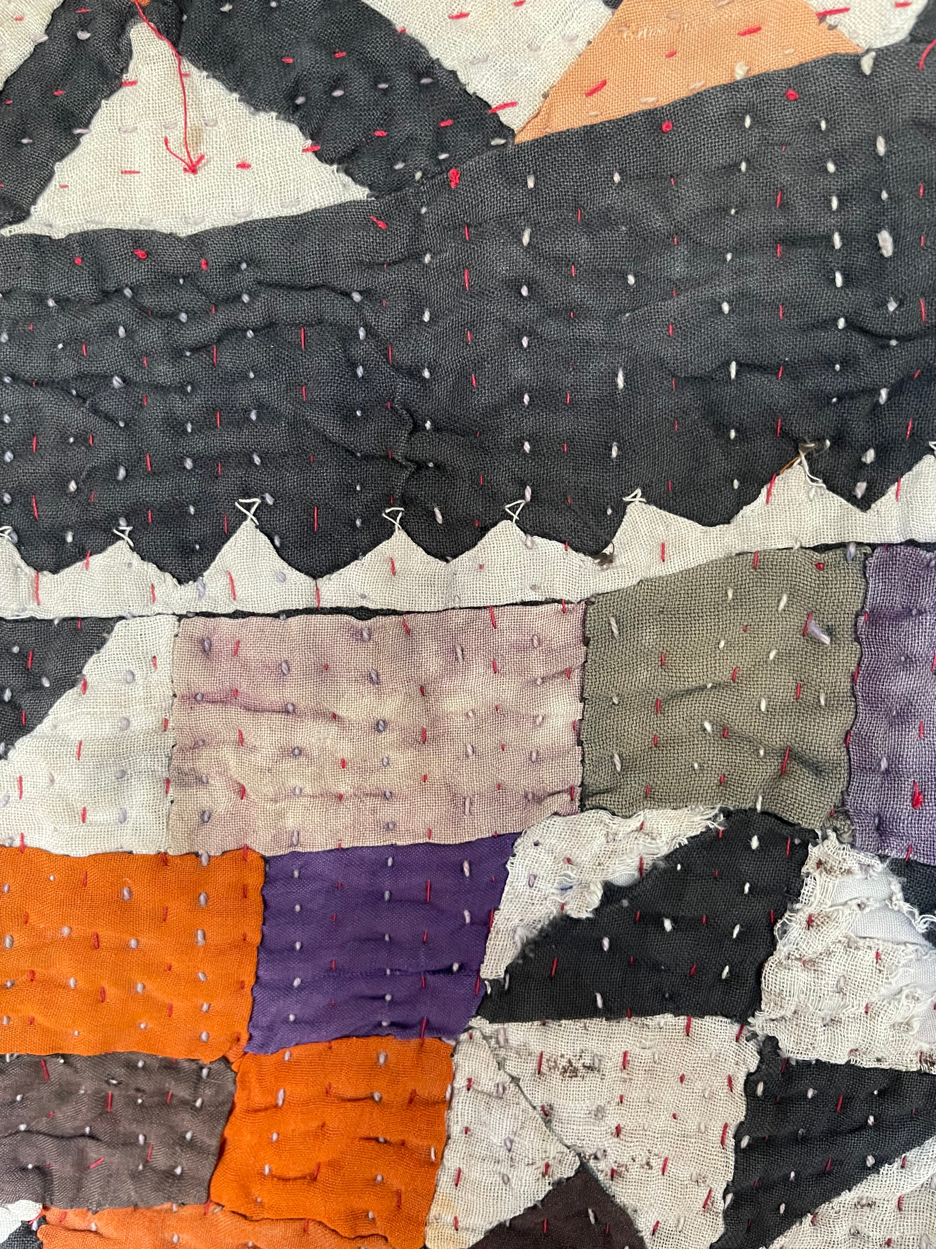 This particular quilt has an unusual combination of triangles and sqaures creating an enchanting and visually disruptive pattern. The reverse a vintage handblock printed piece of fabric that looks like coffee pots printed on the diagonal.