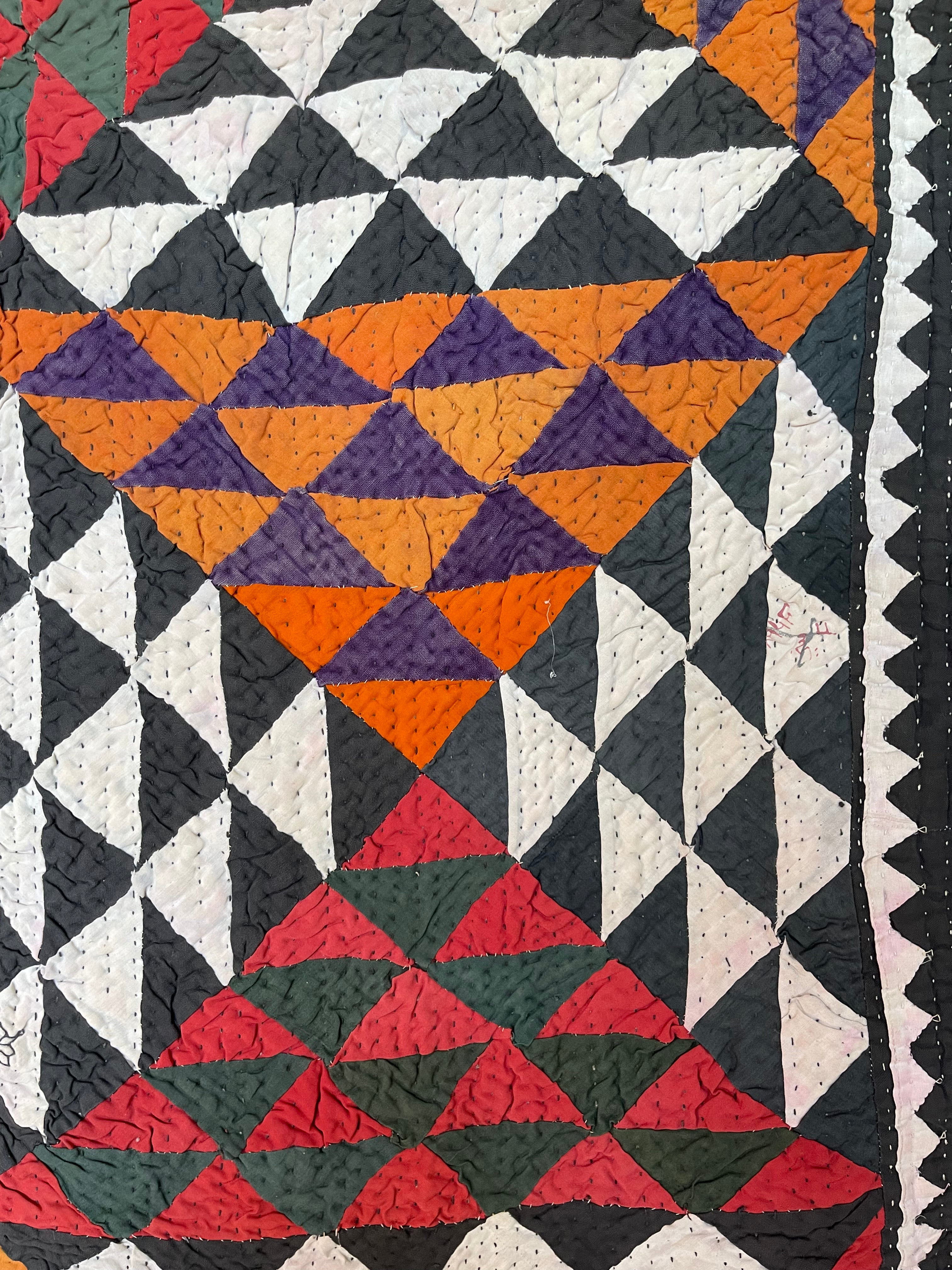 This ralli illustrates one of the most typical everyday quilts. The color scheme is based on the old, natural dyes colors even though chemical dyes are now used. The size of the fabric used in the piecing is typical for an everyday quilt. The geometric design is bold, especially when viewed from a distance.