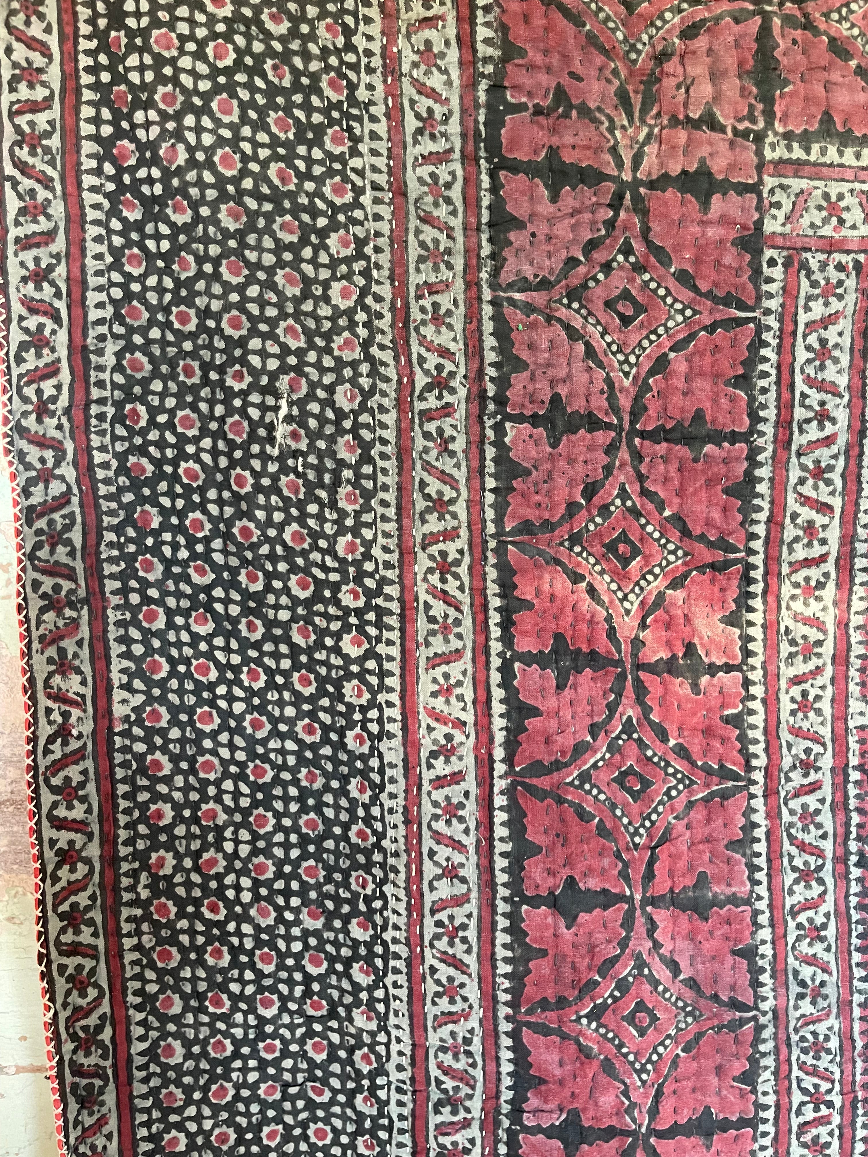 This ralli illustrates one of the most typical everyday quilts. The color scheme is based on the old, natural dyes colors even though chemical dyes are now used. The size of the fabric used in the piecing is typical for an everyday quilt. The geometric design is bold, especially when viewed from a distance.