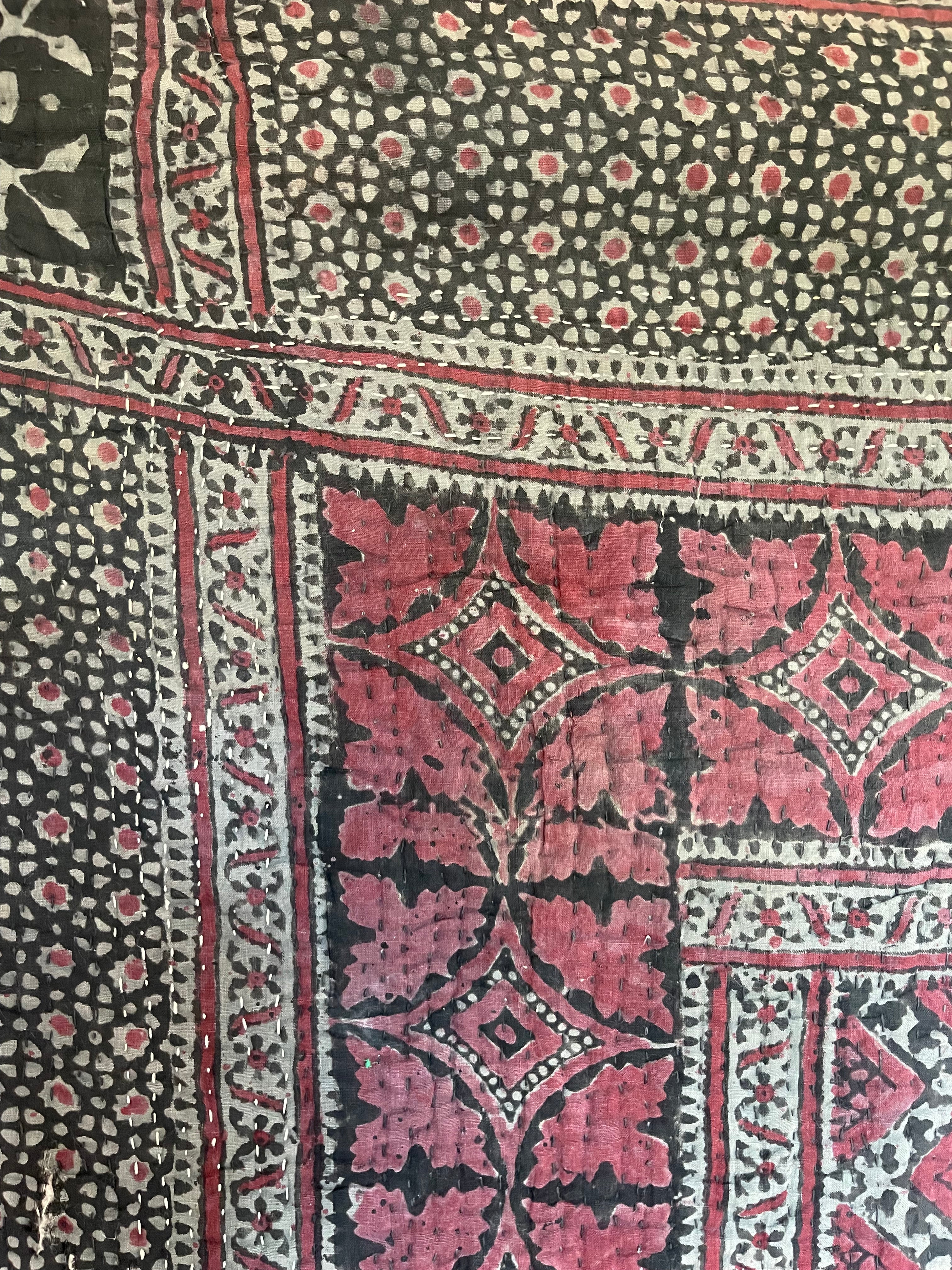 This ralli illustrates one of the most typical everyday quilts. The color scheme is based on the old, natural dyes colors even though chemical dyes are now used. The size of the fabric used in the piecing is typical for an everyday quilt. The geometric design is bold, especially when viewed from a distance.