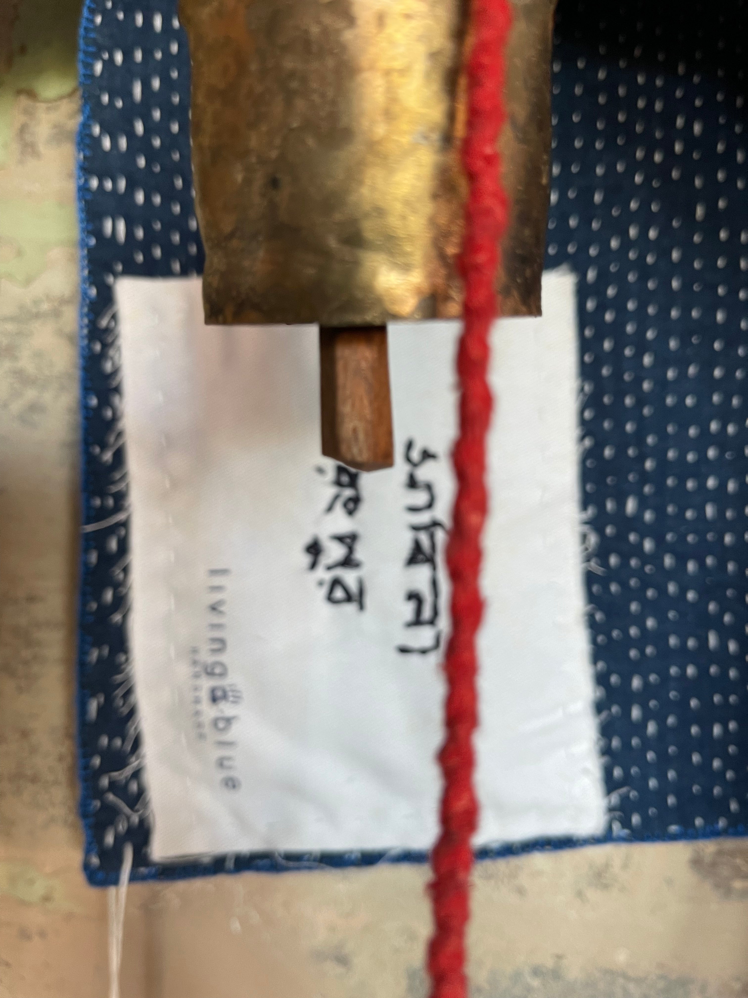 A sunningly beautiful indigo shibori kantha quilt, made by the artisans of LIVING BLUE. The front a check pattern, the reverse showing fine white hand stitiching on a plain indigo background.