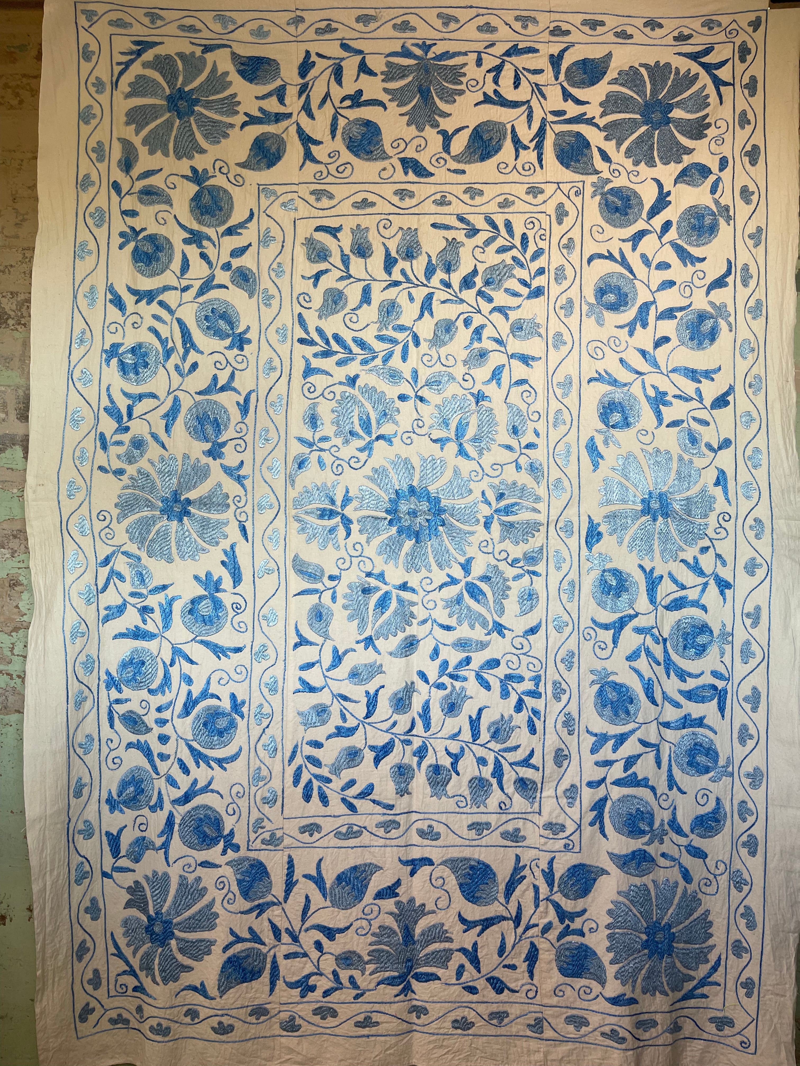 Hand embroidered blue vines suzani on beautifully weighted natural coloured cotton.
