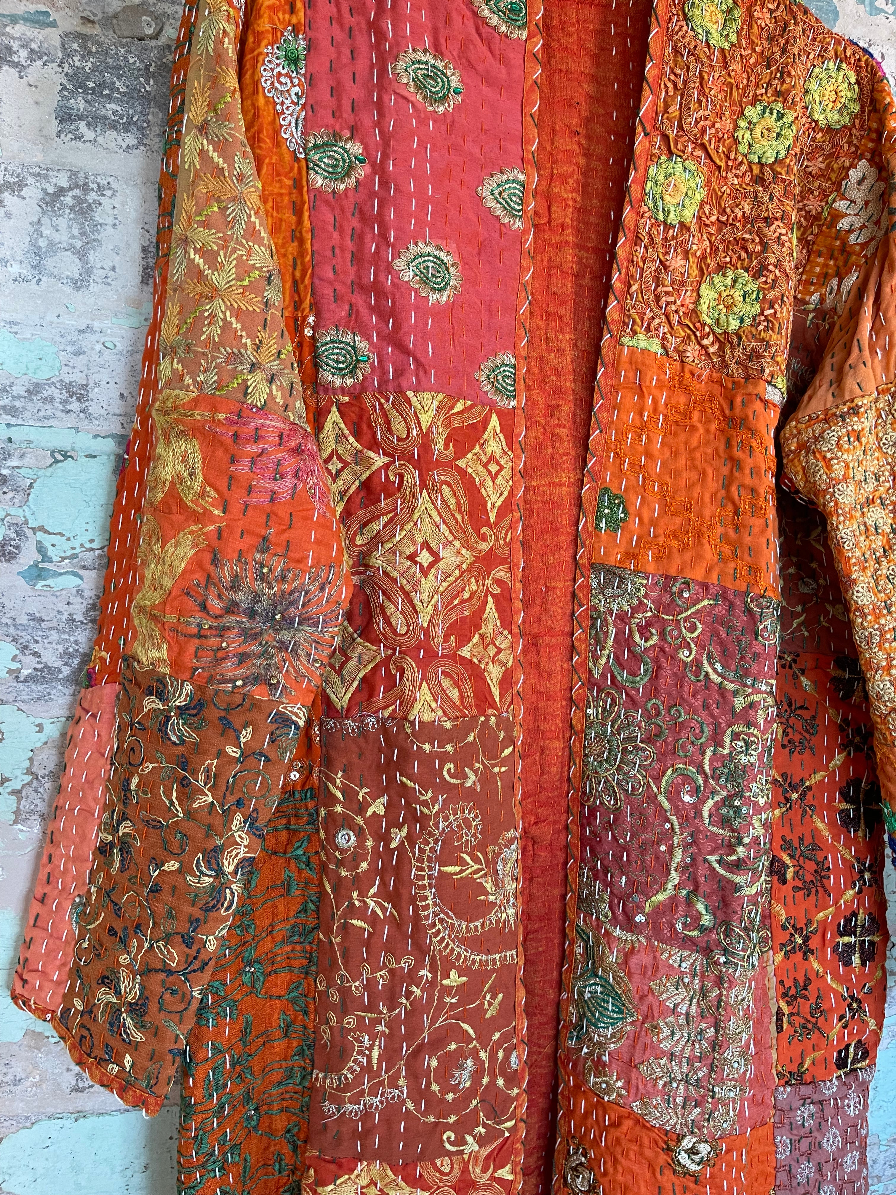 Delightful kantha coat in patchwork of embroidered patterns and sequins. The inside lining plain.