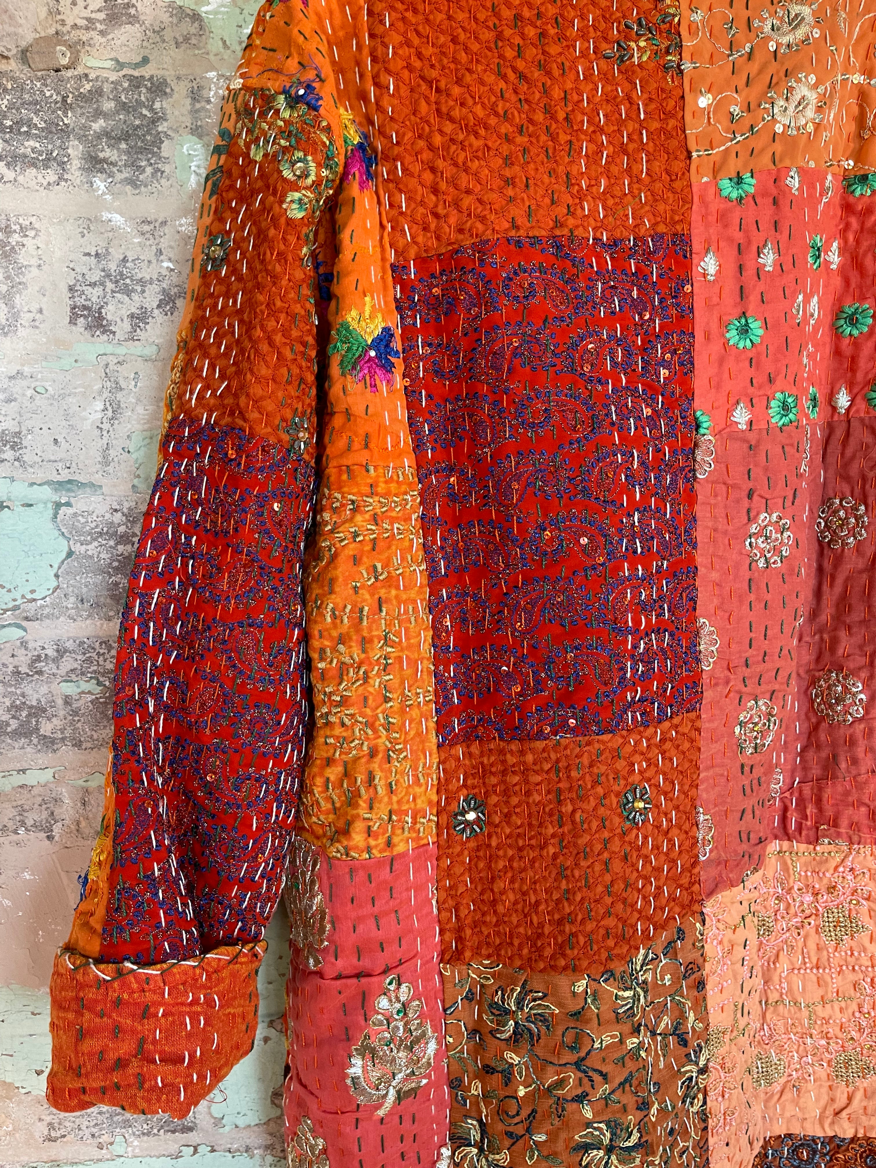 Delightful kantha coat in patchwork of embroidered patterns and sequins. The inside lining plain.