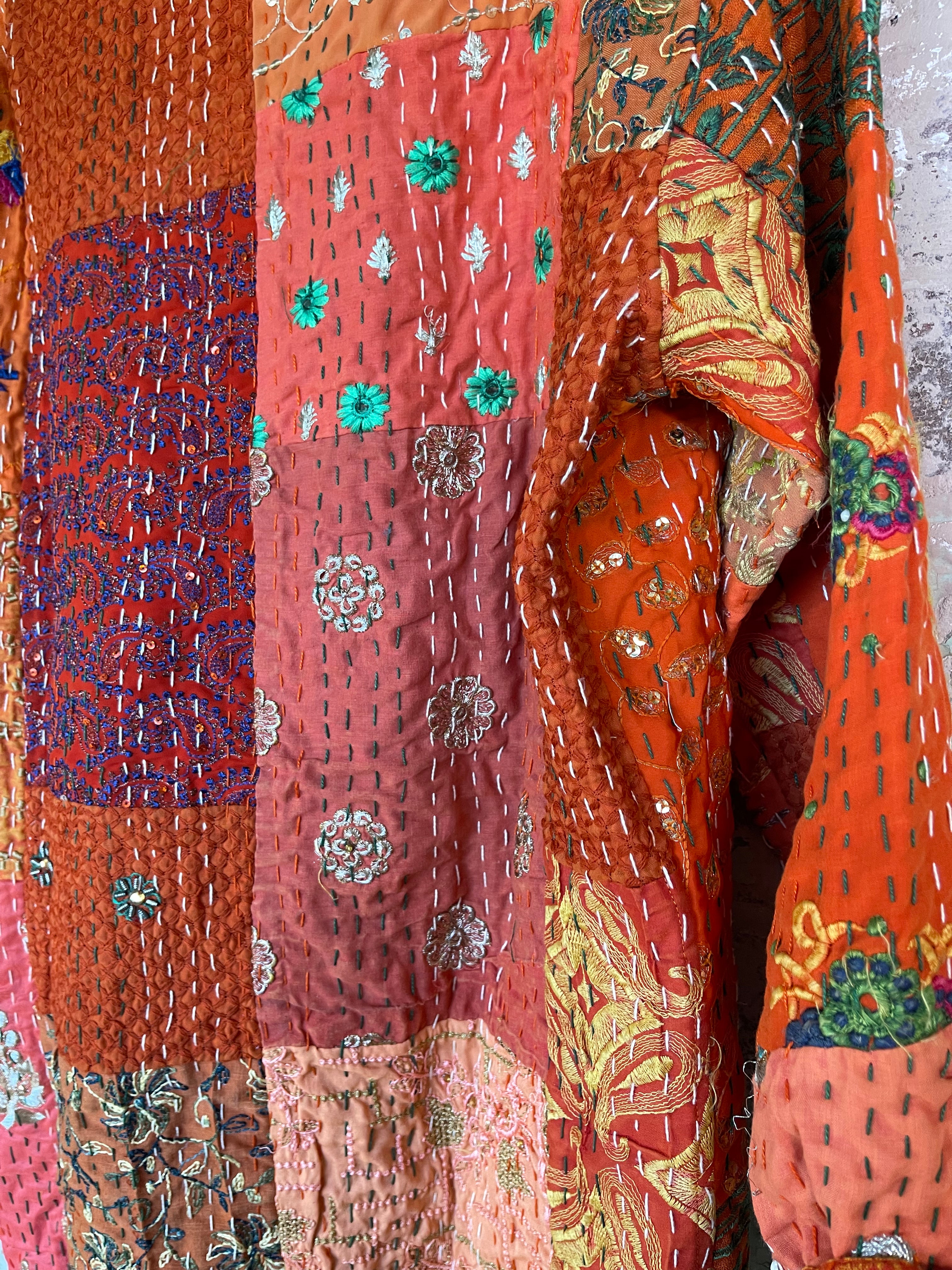 Delightful kantha coat in patchwork of embroidered patterns and sequins. The inside lining plain.