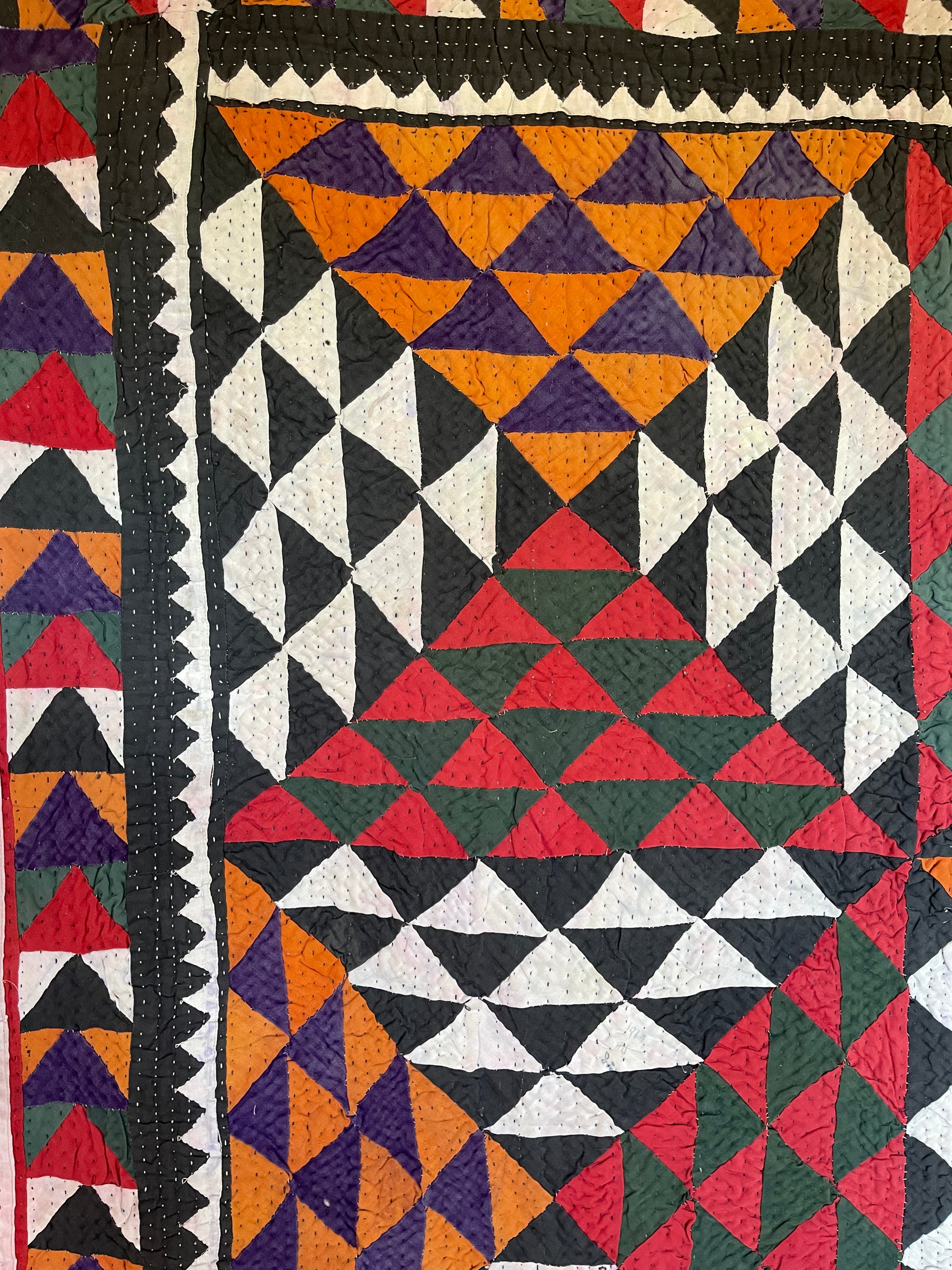 This ralli illustrates one of the most typical everyday quilts. The color scheme is based on the old, natural dyes colors even though chemical dyes are now used. The size of the fabric used in the piecing is typical for an everyday quilt. The geometric design is bold, especially when viewed from a distance.