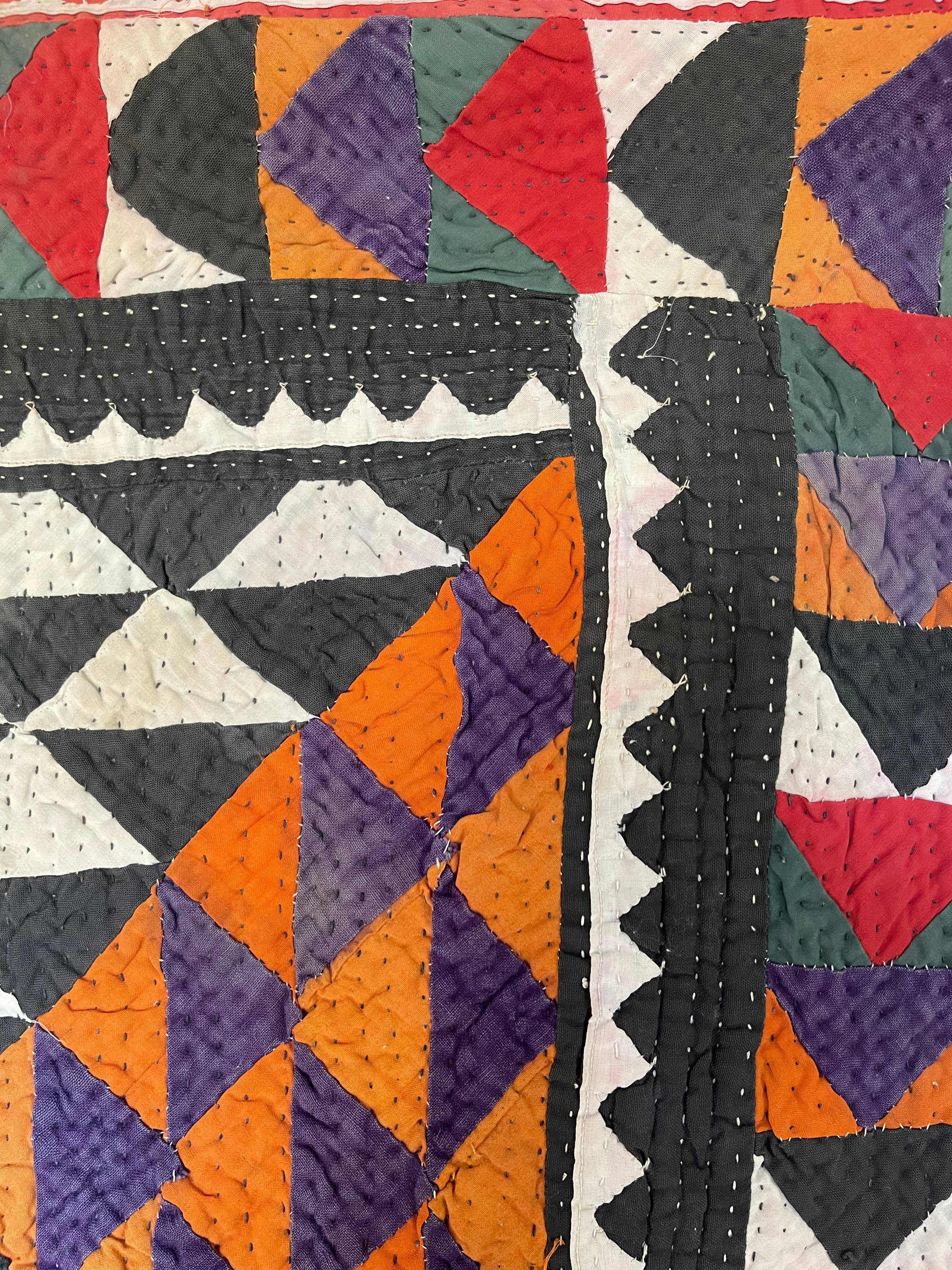 This ralli illustrates one of the most typical everyday quilts. The color scheme is based on the old, natural dyes colors even though chemical dyes are now used. The size of the fabric used in the piecing is typical for an everyday quilt. The geometric design is bold, especially when viewed from a distance.