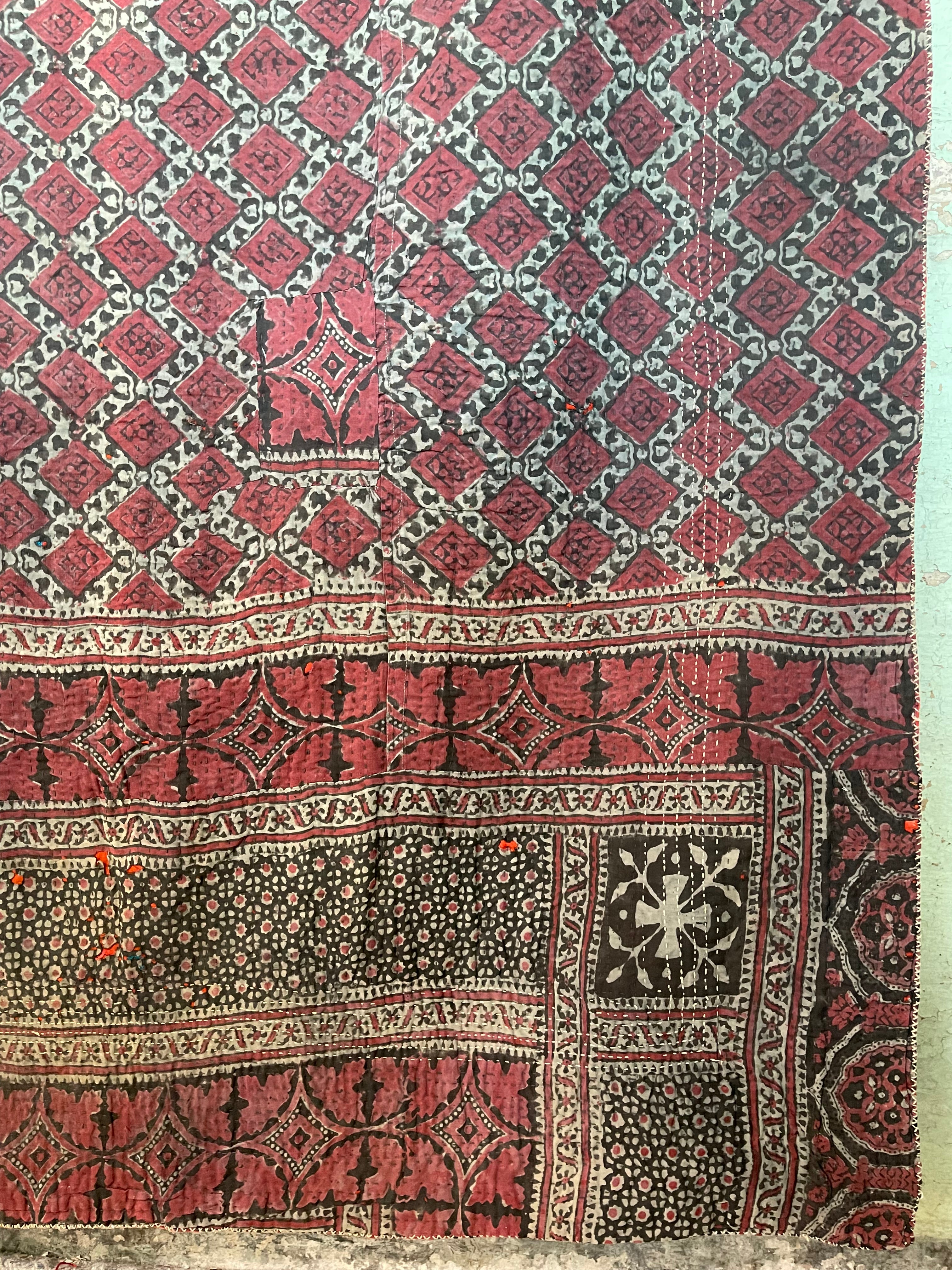 This ralli illustrates one of the most typical everyday quilts. The color scheme is based on the old, natural dyes colors even though chemical dyes are now used. The size of the fabric used in the piecing is typical for an everyday quilt. The geometric design is bold, especially when viewed from a distance.